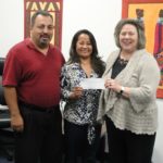 Alenda and Juan Valenzuela donating check to CAFI